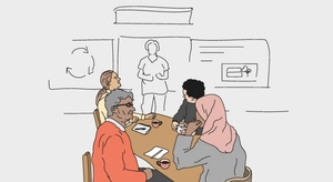 Personer kring ett bord i ett klassrum.