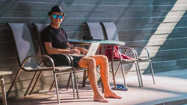 Man with laptop in his knee