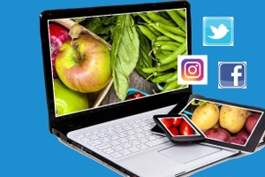 Laptop, mobiltelefon och läsplatta med frukt och grönt. Twitter, Facebook och Instagram loggor.