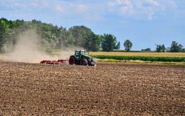 Plöjande traktor på åker