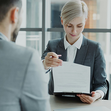 Two people going through documents. Photo.
