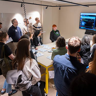 Computer users demonstrating their assistive devices. Photo.