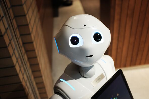 En vit robot med svarta runda ögon och en liten mun.