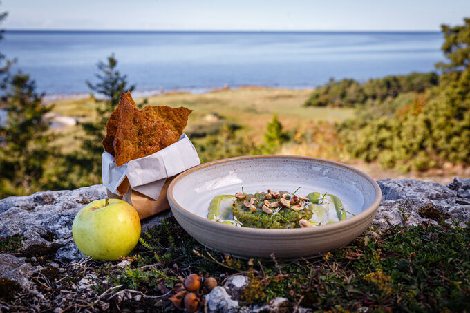 Ett arrangemang av en måltid ute i det fria. Havet i bakgrunden